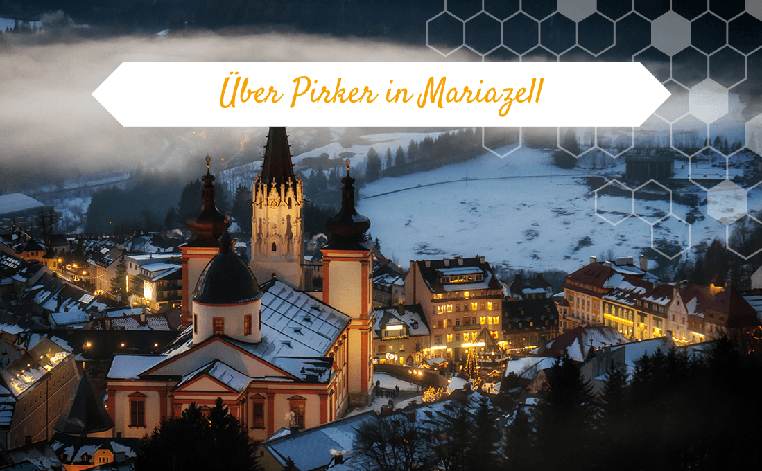 Über Pirker in Mariazell – Winterblick auf beleuchtete Basilika und Altstadt im Schnee.