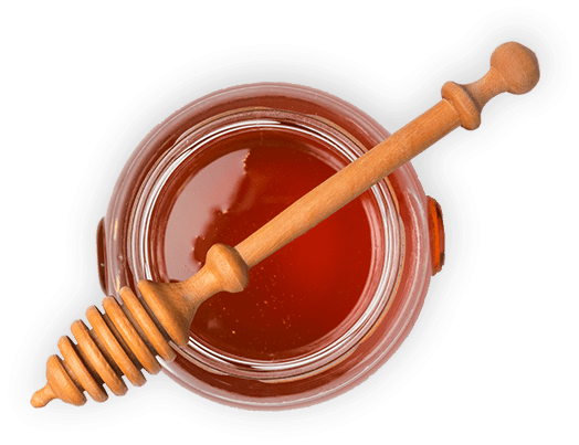 Honigtopf mit Honiglöffel (Freisteller) – echter Bienenhonig als Zutat der Pirker Lebzelterei.
